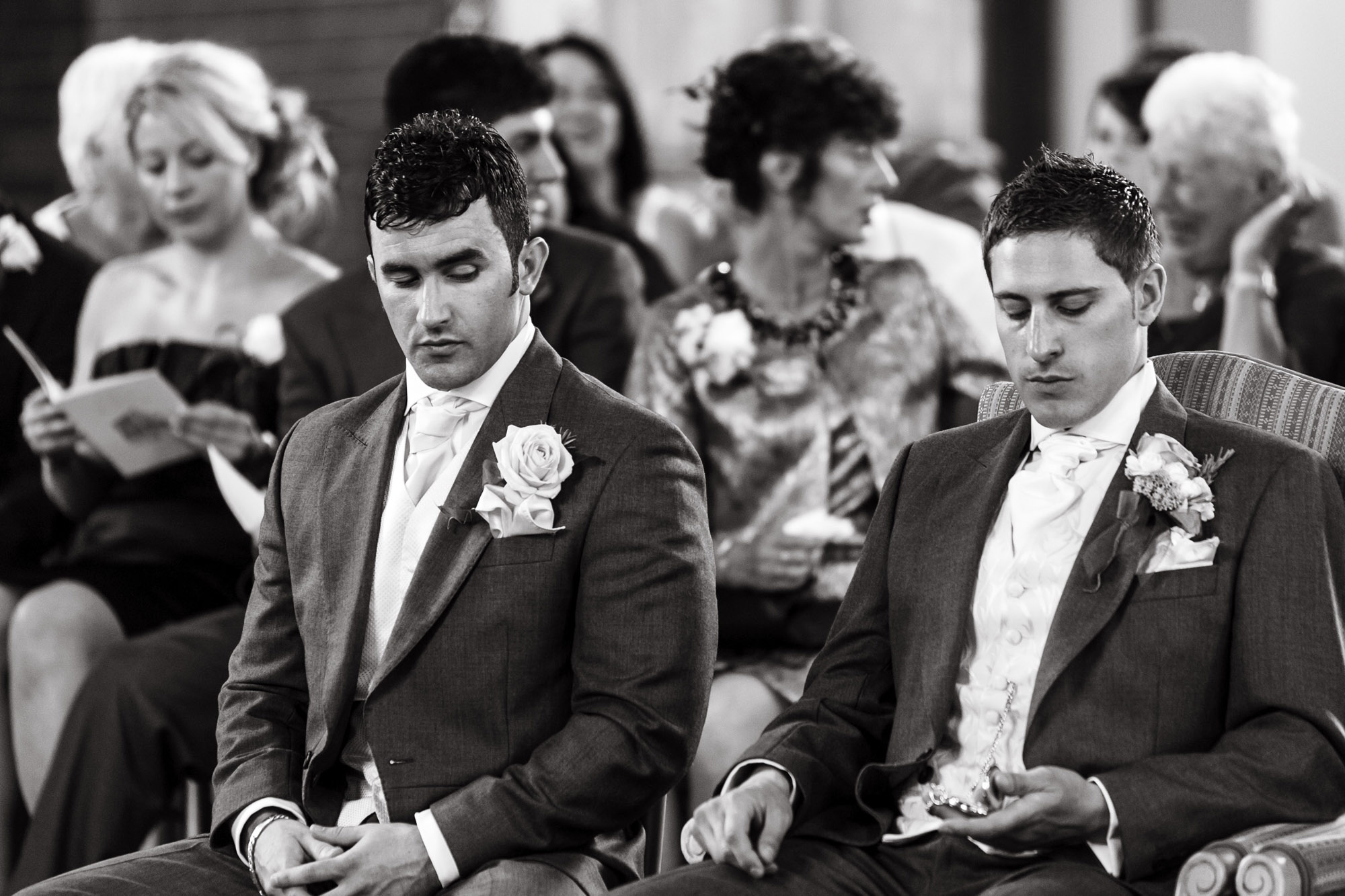 The groom checks his watch on his wedding day taken by Surrey based wedding photographer Richard Eaton. 